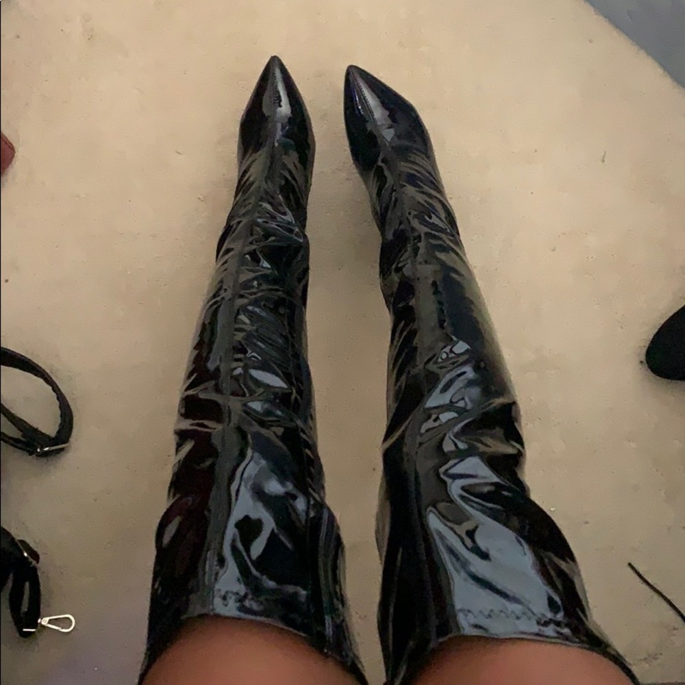 Patent leather thigh high pointy toe boot.